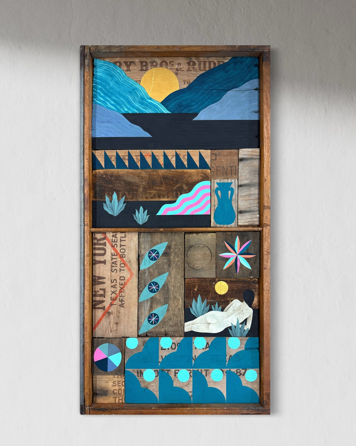 Artistic wall piece with geometric shapes and patterns on a wooden frame.